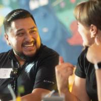 Man smiling at woman he is talking to